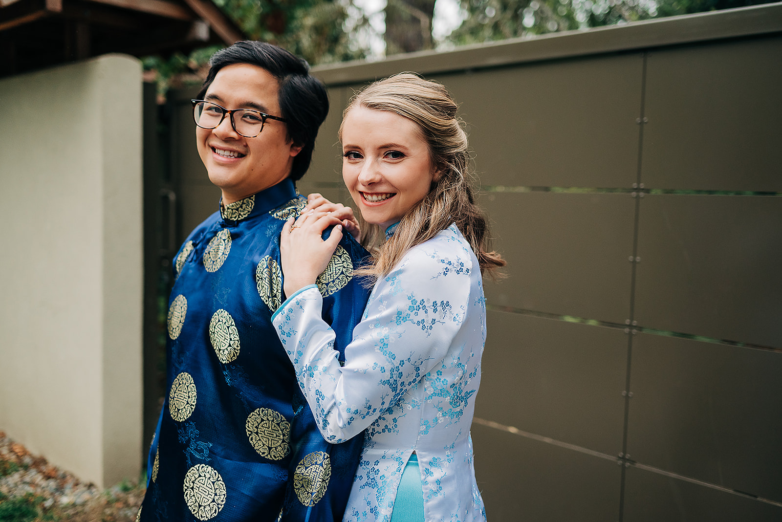 Interracial couple photographed in traditional ao dai attire at engagement session at Kubota garden in Seattle