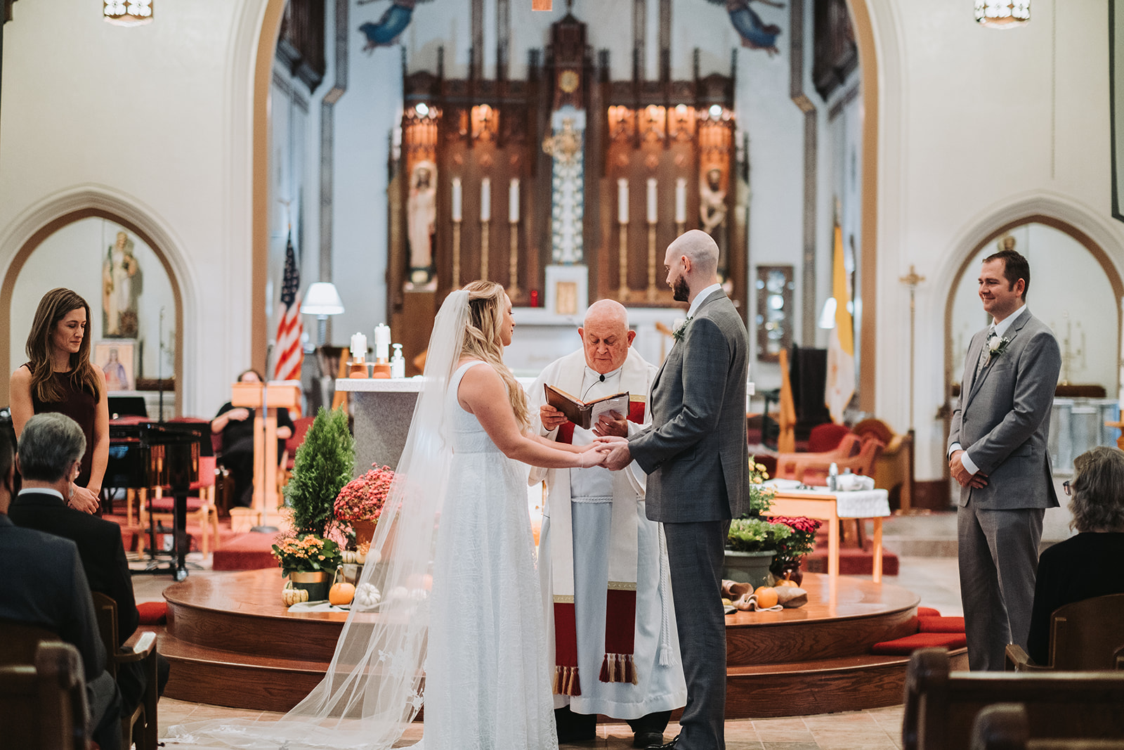 Couple saying vows in an intimate catholic church wedding. 