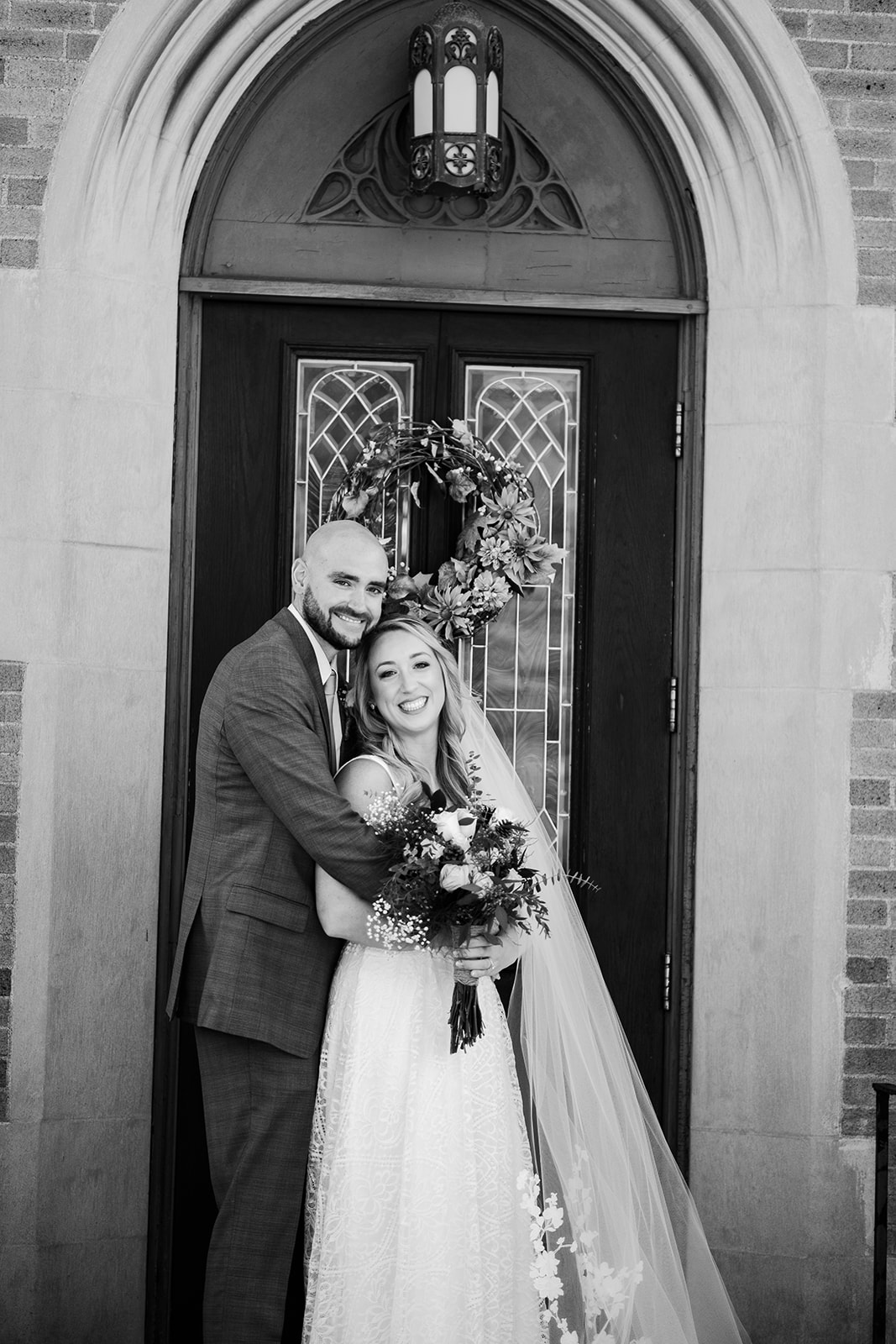 Couples black and white portraits outside of church in Westford, MA. 