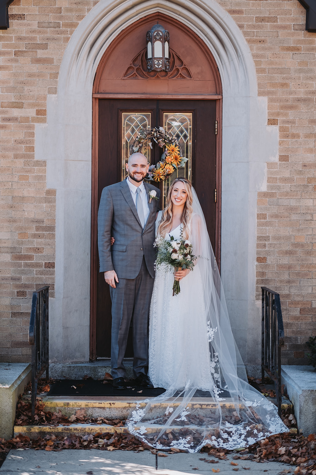 Fall portraits of married couple outside of church in Massachusetts 
