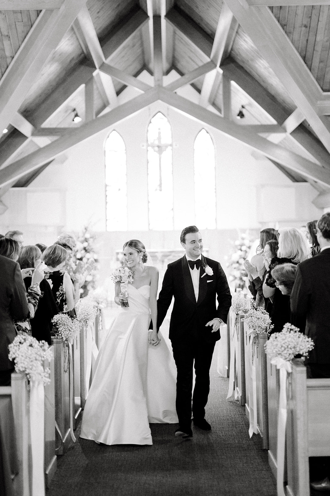 bride and groom recess down church aisle after ceremony
