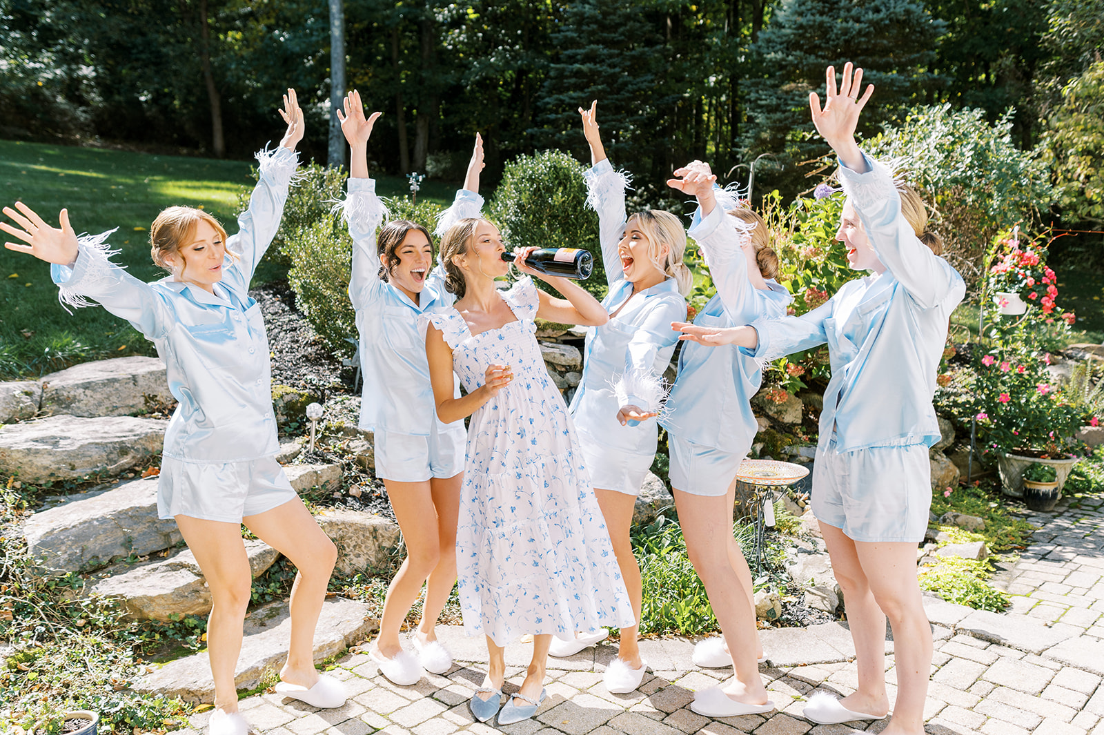 cheering bridesmaids in blue pajamas