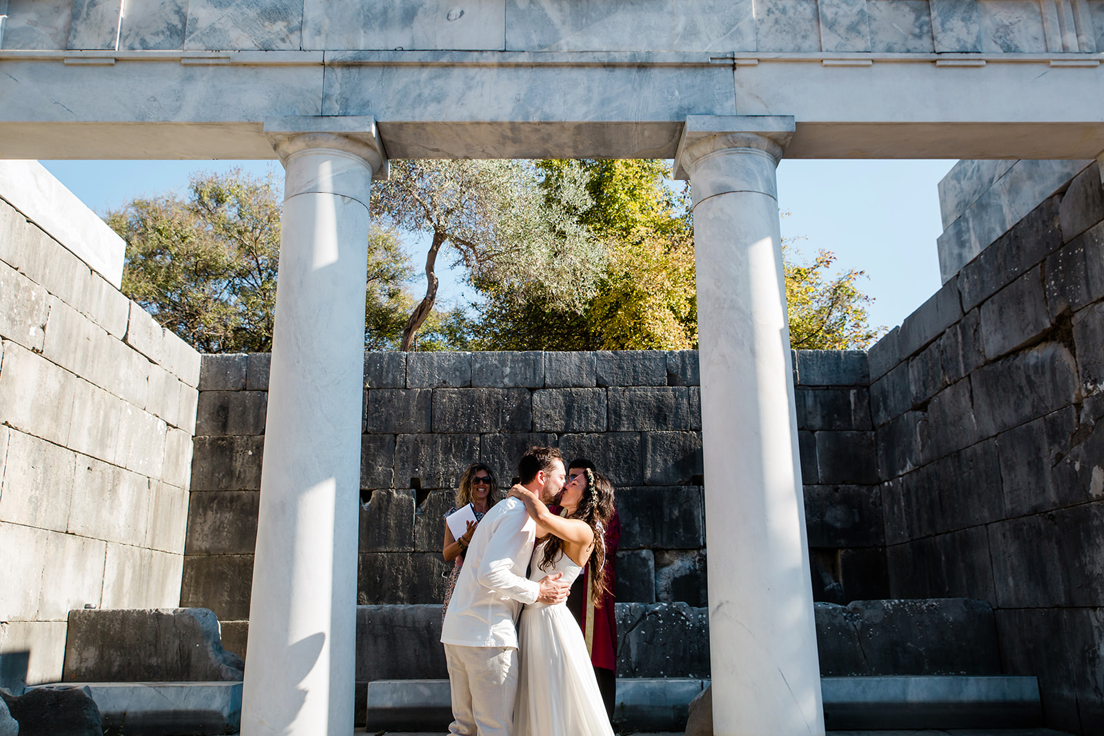 Bride and groom kissing after the ceremony in Dalyan, Kaunos ruins