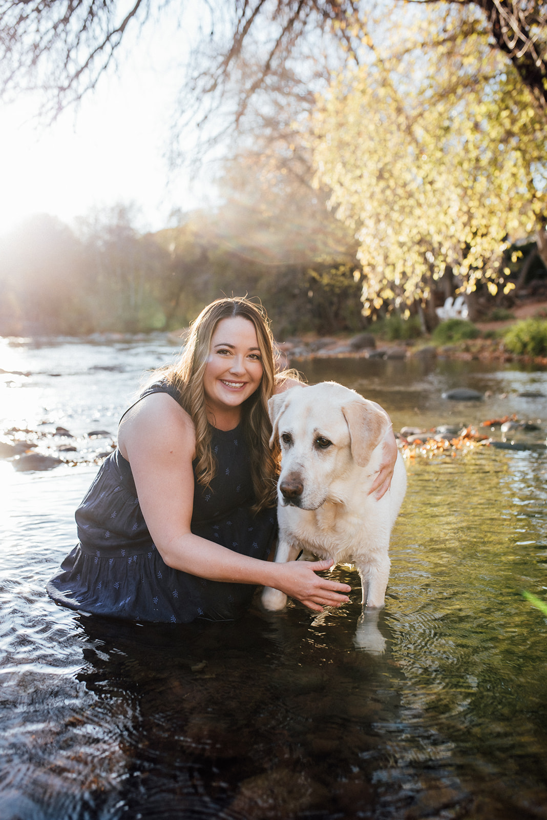 woman with her dog in Oak creek in Sedona