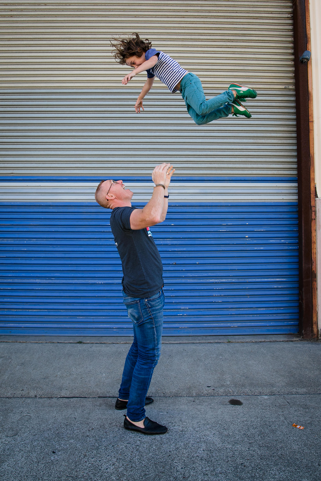 photo of dad throwing kid in the air