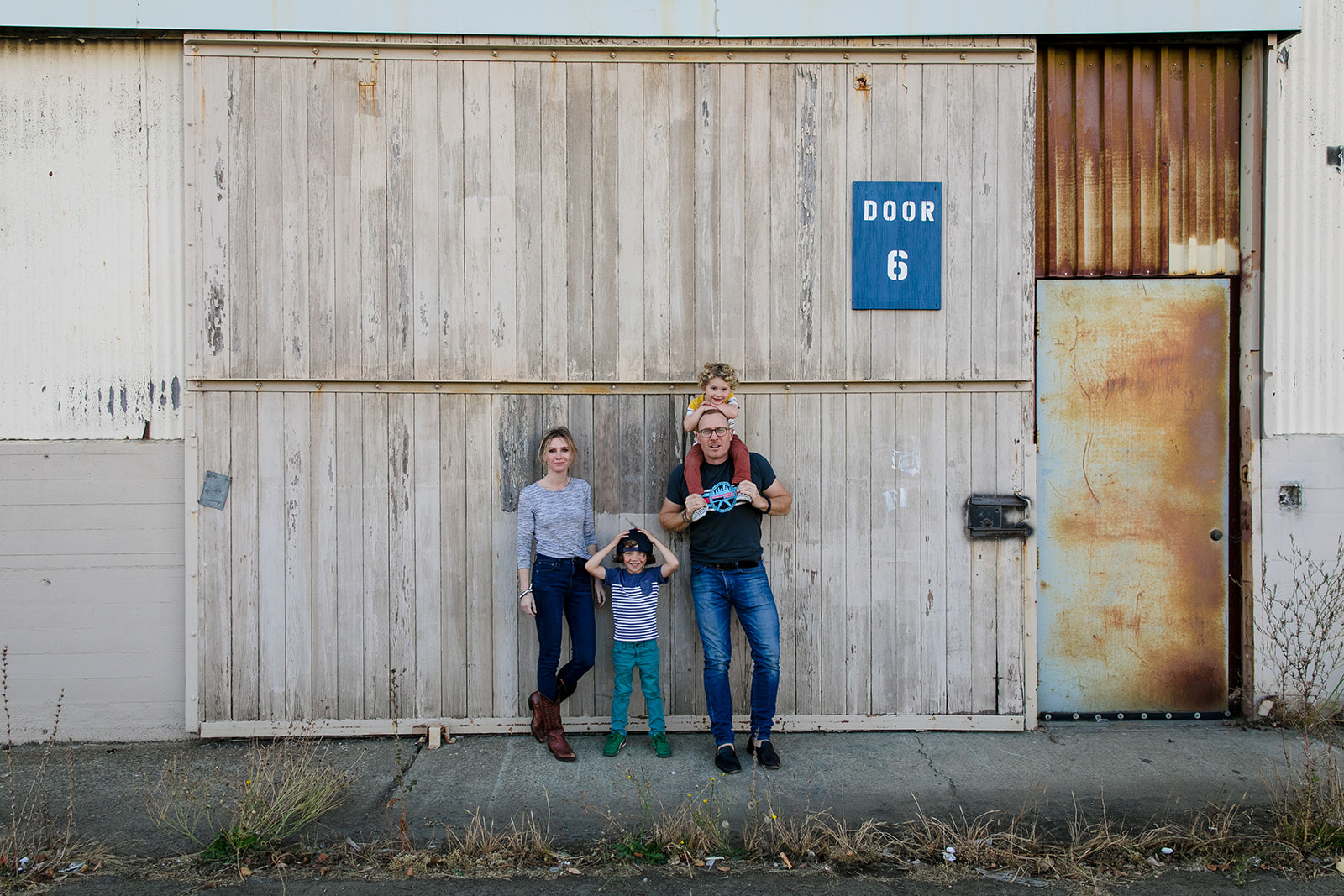family portrait in front of warehouses in alameda california