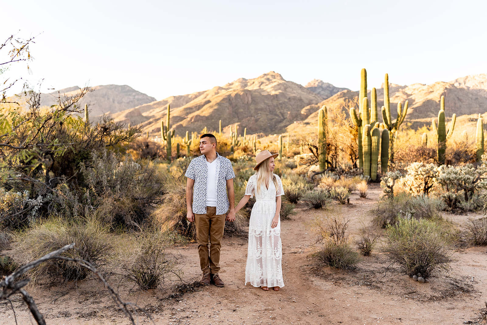 couple at sabino canyon engagement session with mountains in background