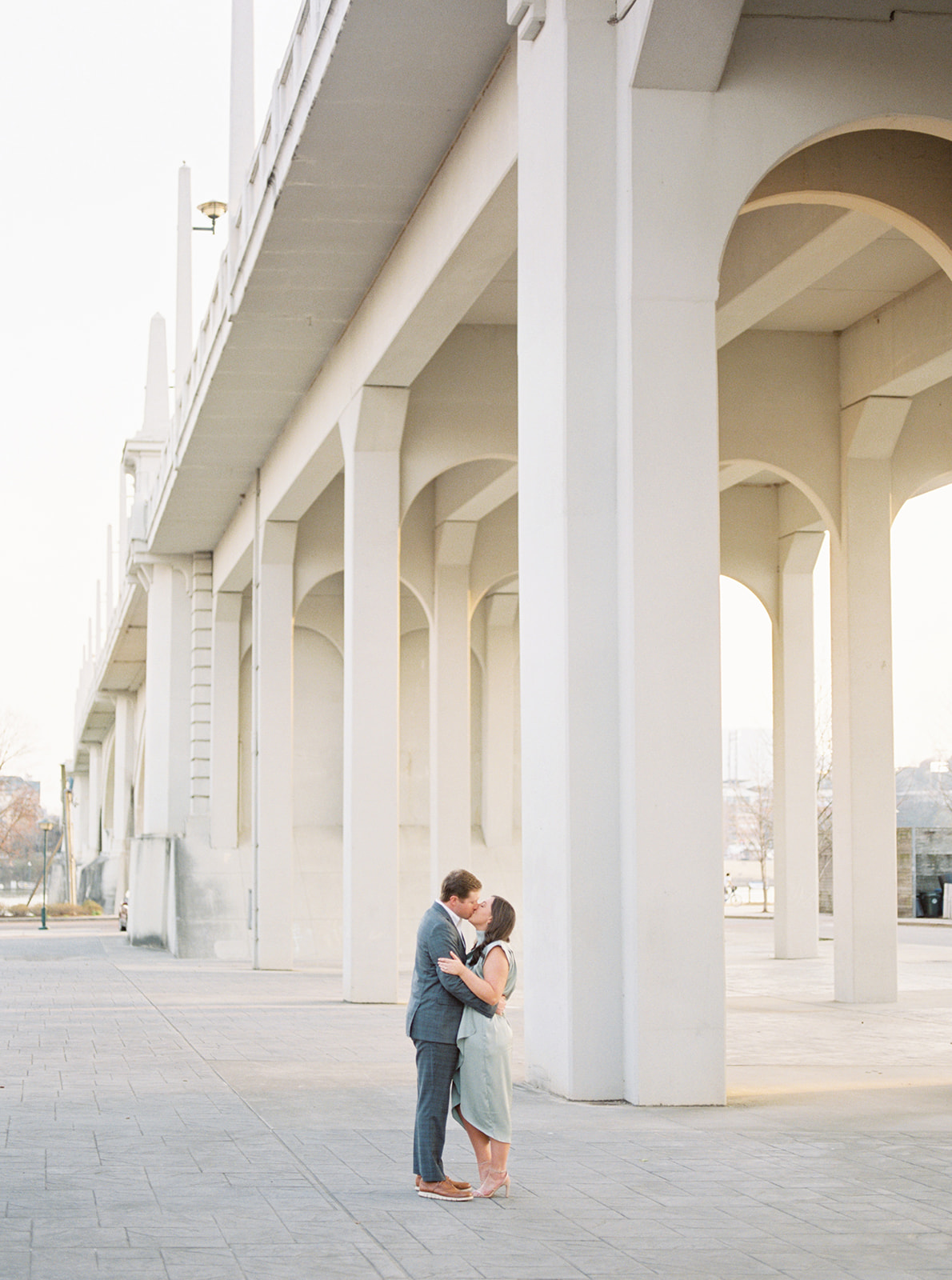 A couple kisses under the Market Street Bridge at Coolidge Park in Chattanooga, Tennessee