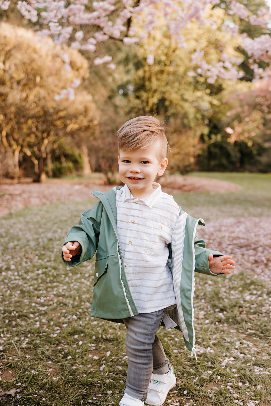 A candid photo of a young smiling toddler running in a Seattle park.