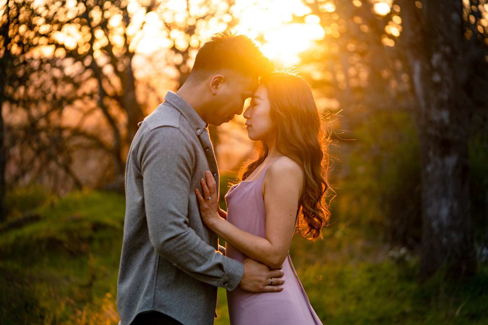 An emotive couple surrounded by golden hour light at their engagement session in Victoria BC
