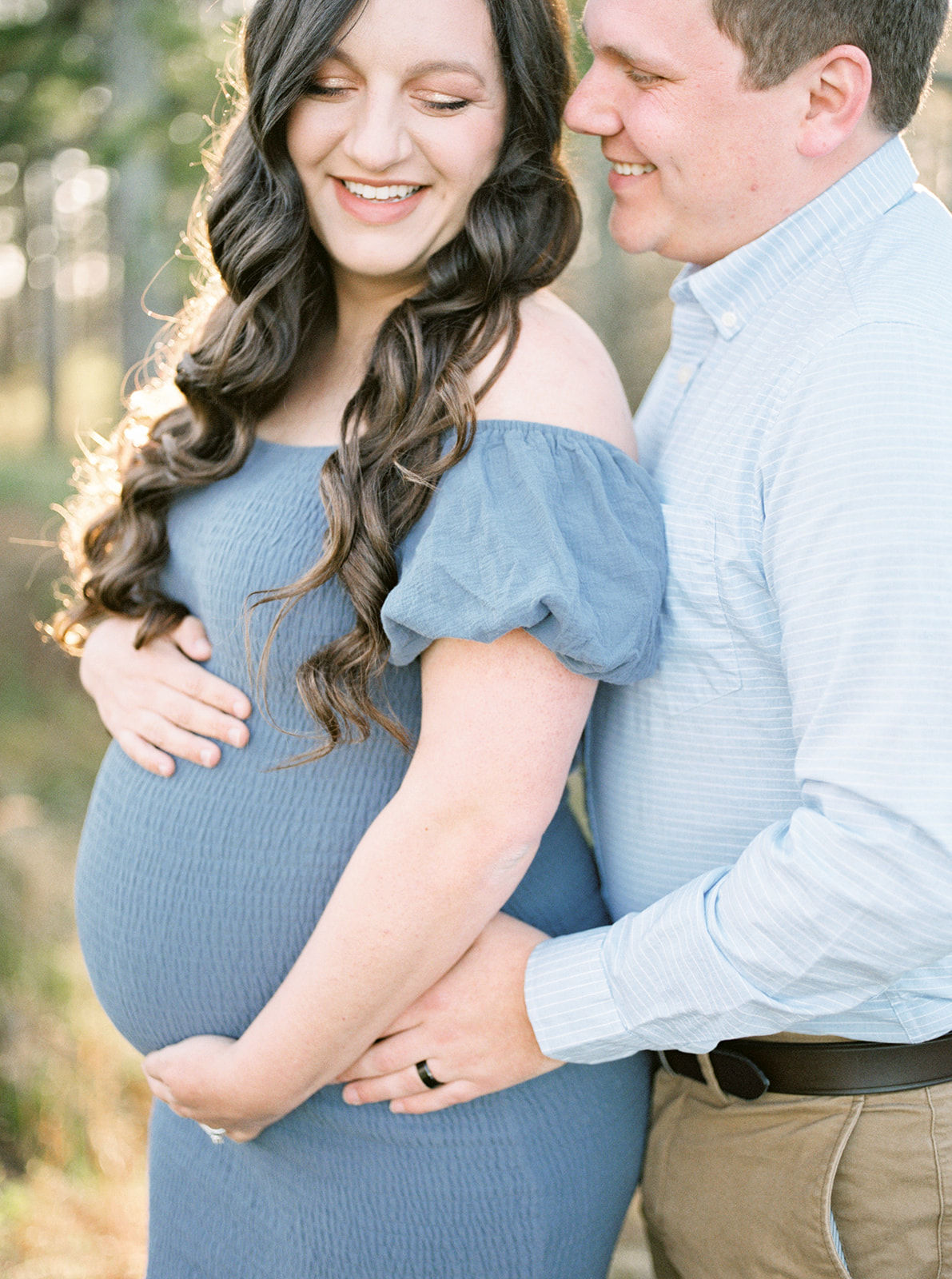The couple poses at DeKalb County Lake for their spring maternity shoot in Sylvania, Alabama