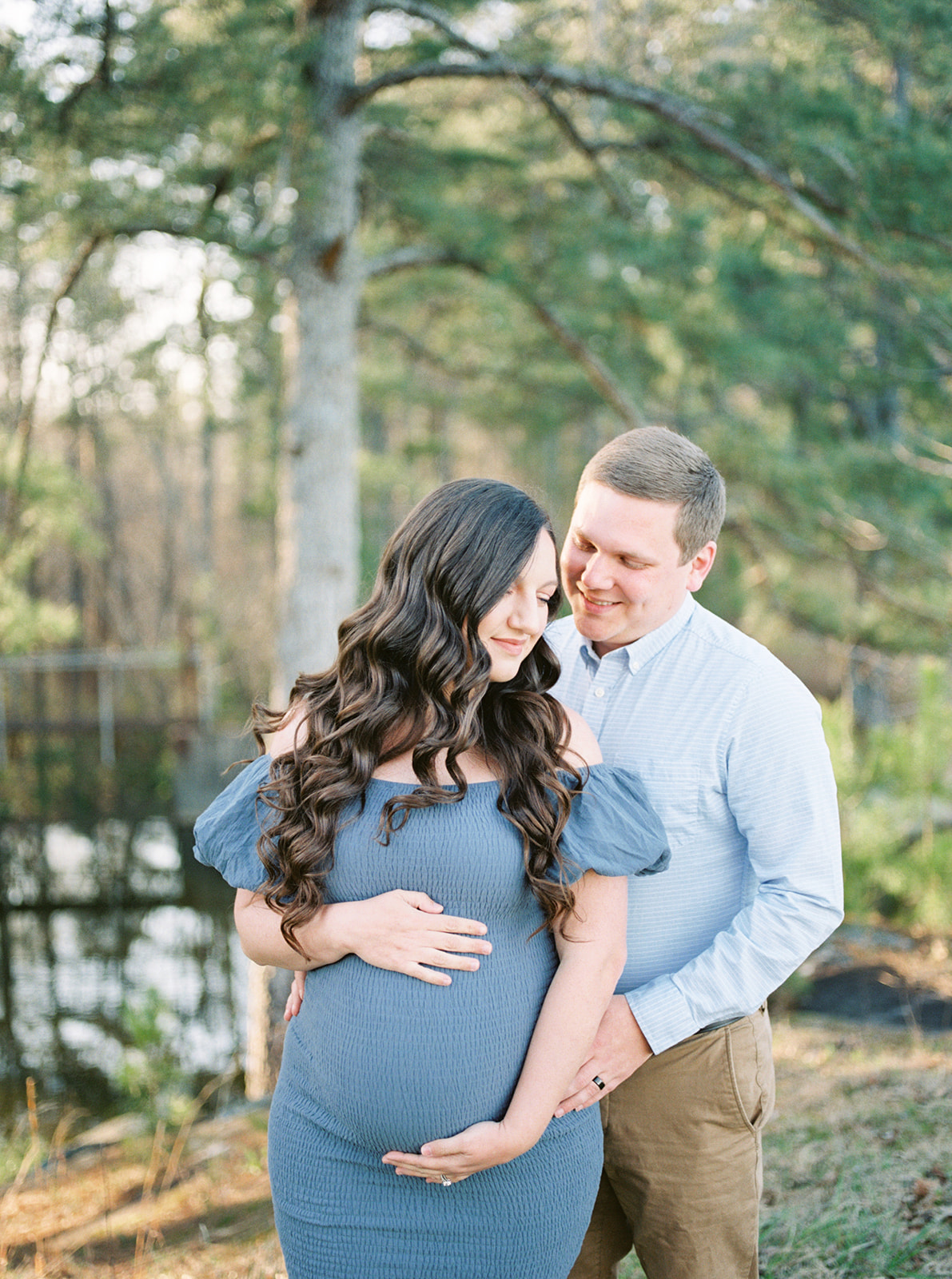 The couple poses at DeKalb County Lake for their spring maternity shoot in Sylvania, Alabama
