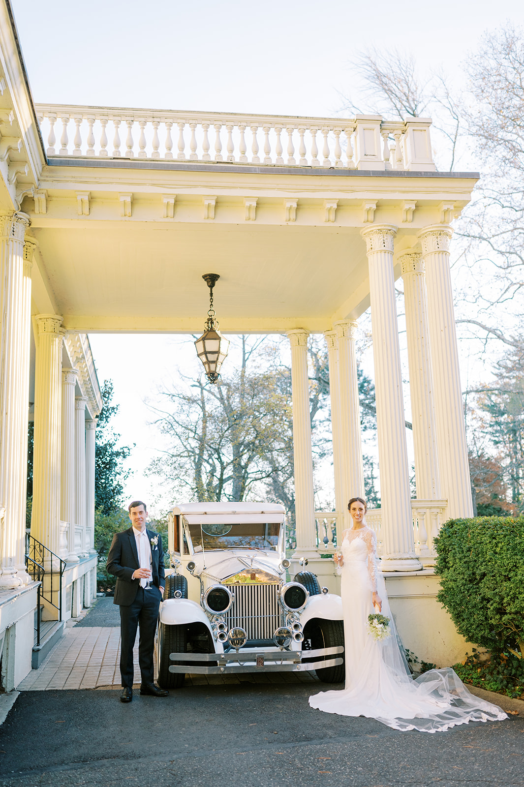 photo of couple in front of glen foerd with antique classic rolls-royce