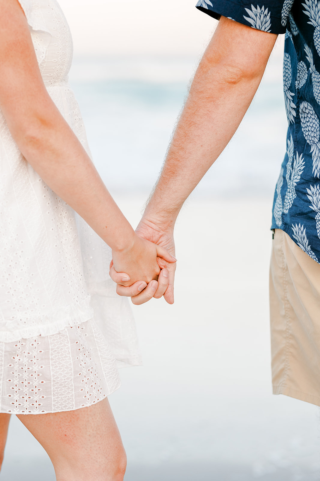 Couple holding hands on the beach in Wilmington, North Carolina