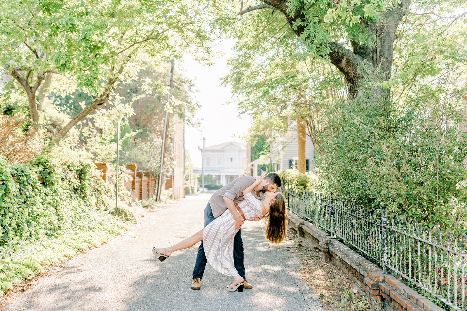 Couple kissing while dipping on the cobblestone streets in Wilmington, North Carolina