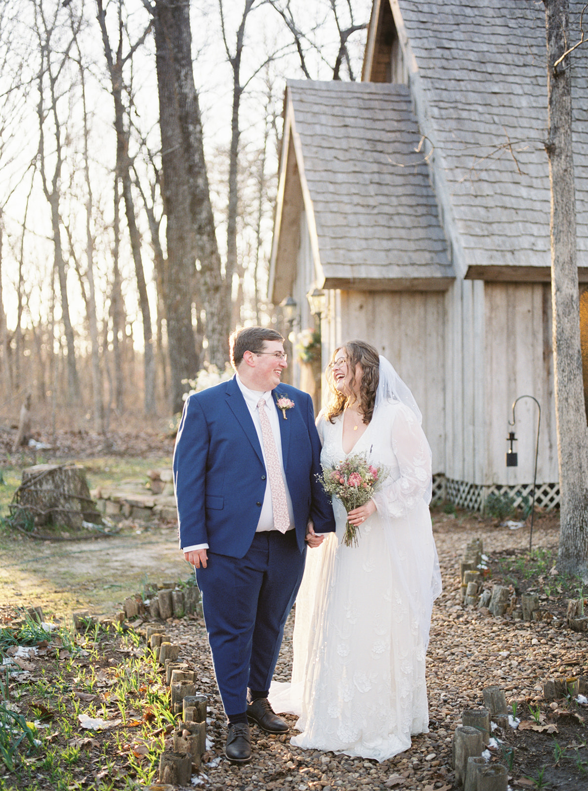 The bride and groom stand outside the chapel at Fernwood in Mentone, Alabama during winter