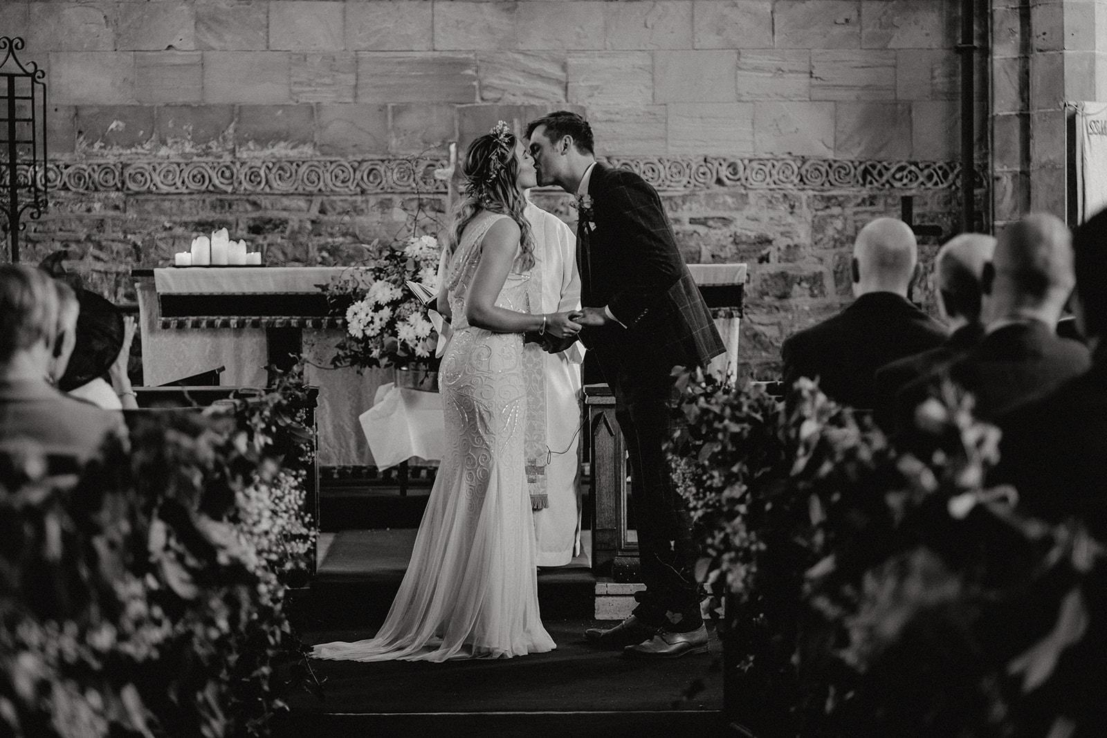First kiss during wedding ceremony at Breedon on the hill church
