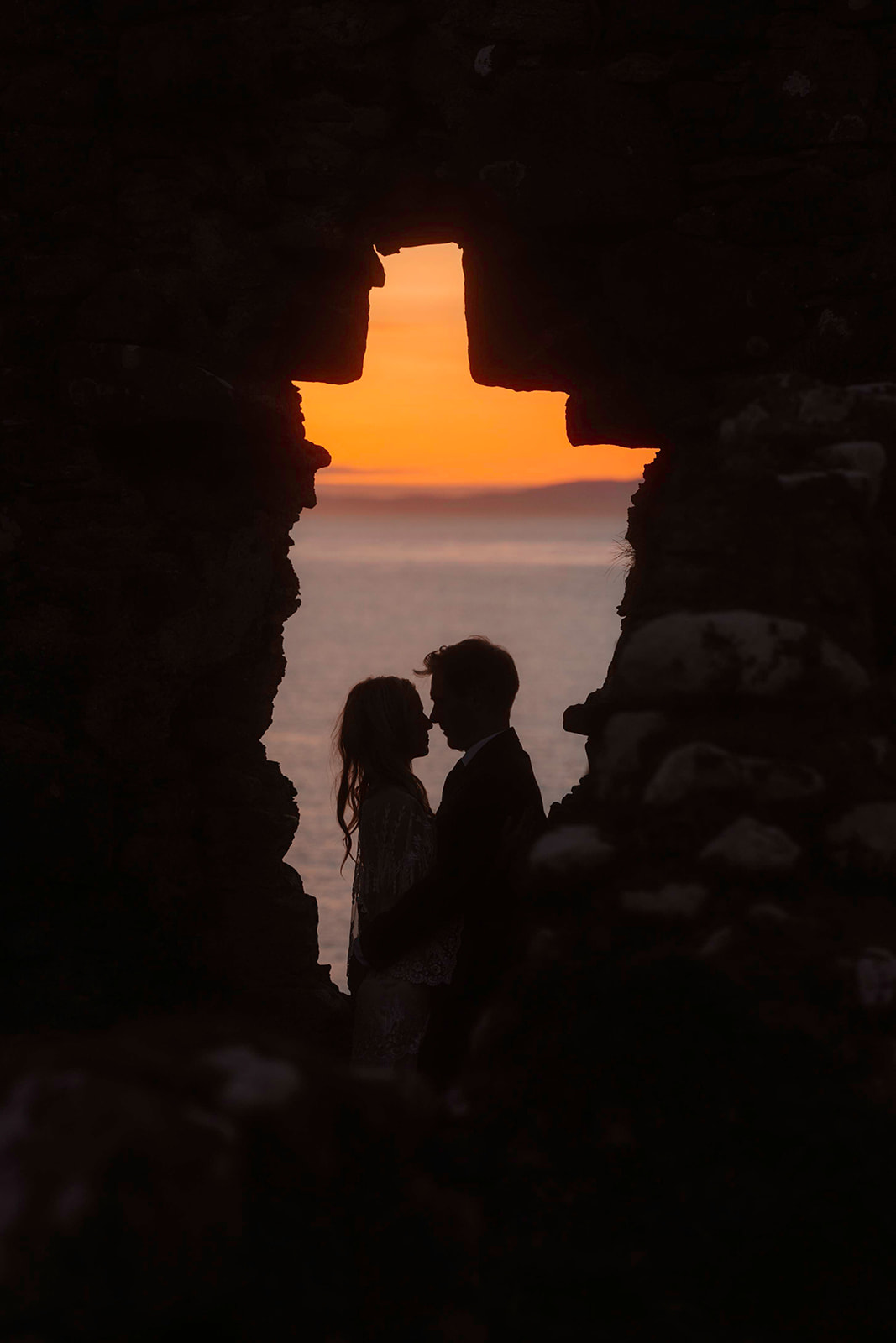 Kara and Andy bask in the glory of the breathtaking sunset at the enchanting Isle of Skye.