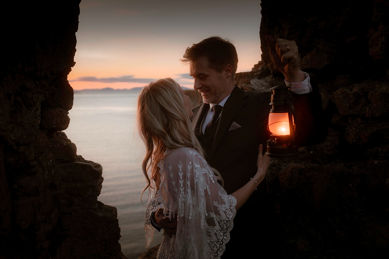Kara and Andy bask in the glory of the breathtaking sunset at the enchanting Isle of Skye.
