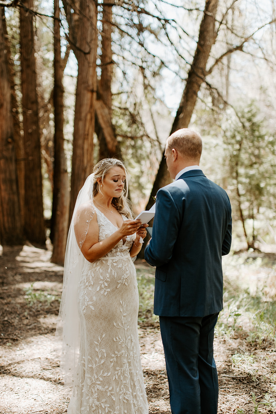 Couple reading their vows in the forest 