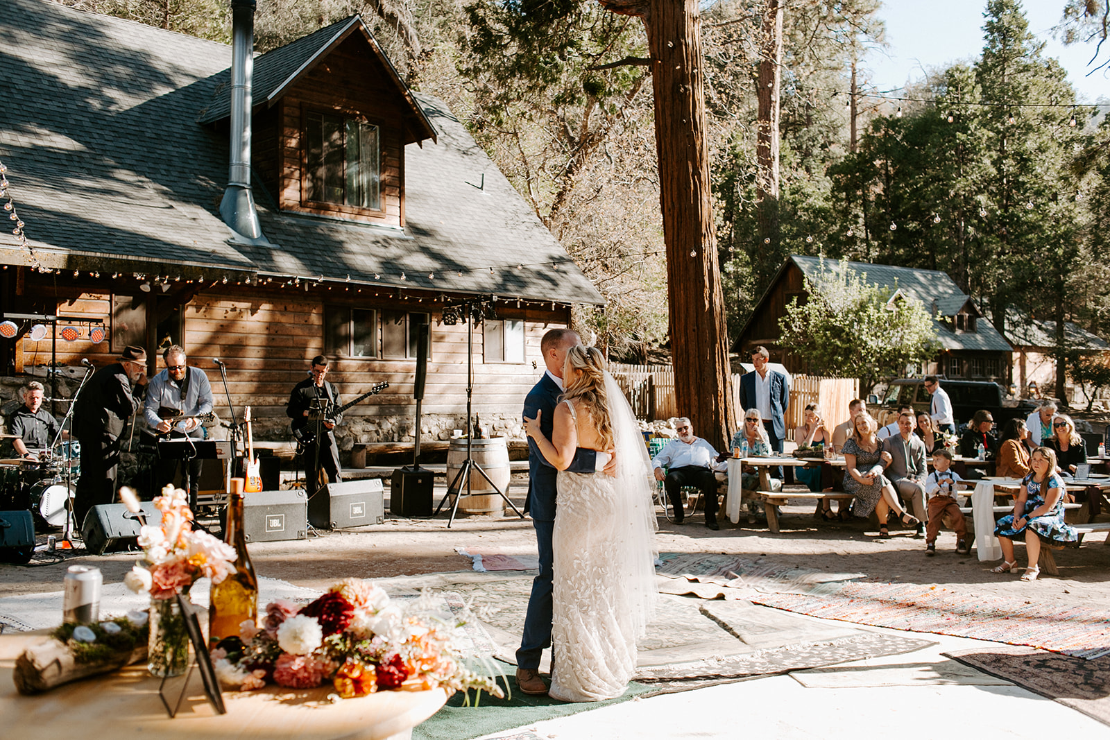 A couples first dance at their Summer camp wedding in the California  mountains 
