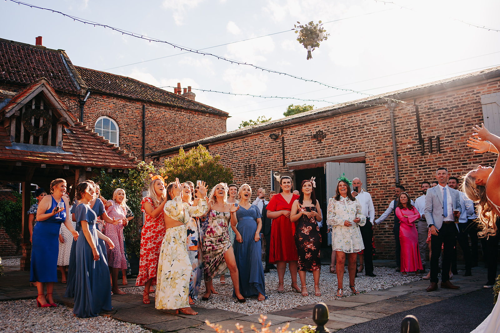 bride throwing bouquet outisde at hornington manor