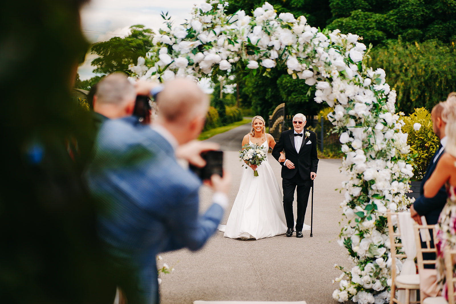 bride walking down aisle for an outdoor Yorkshire ceremony 