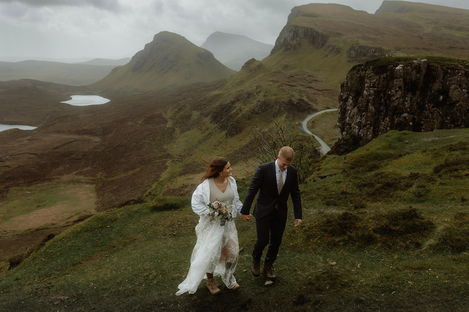 Elopement couples Emma and Matthew walked hand in hand at Quiraing, Isle of Skye.