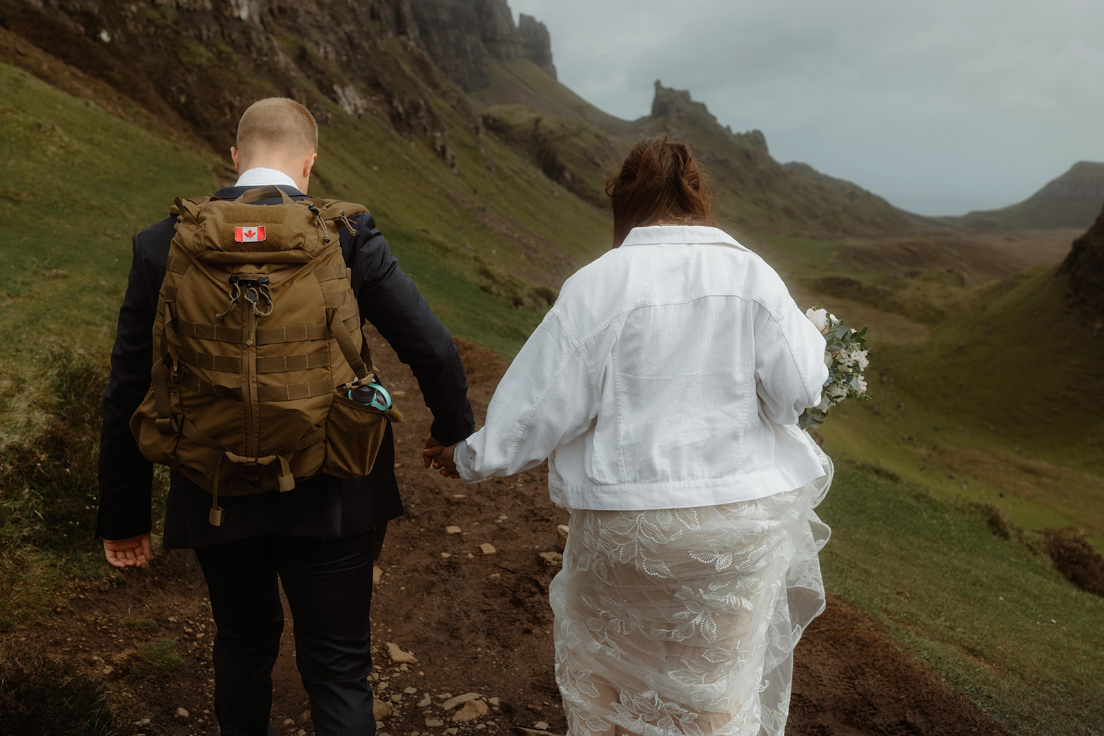 Hand in hand, Emma and Matthew enjoy a romantic walk at the stunning Quiraing, Isle of Skye, on their special elopement 