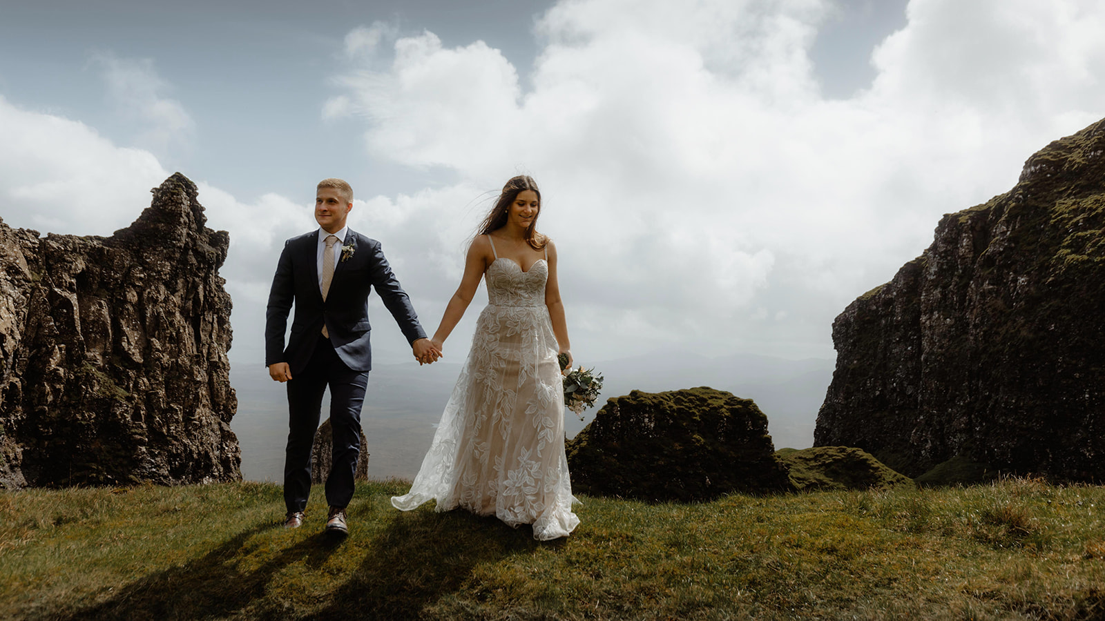 Emma and Matthew walked hand in hand as they stroll around Quiraing, Isle of Skye, during their elopement day.