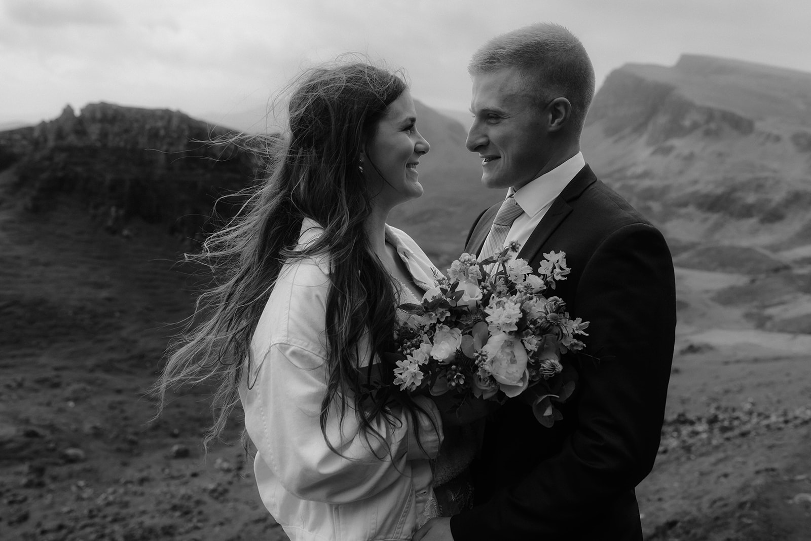 Elopement couples Emma and Matthew looking lovingly at each other on the Isle of Skye.