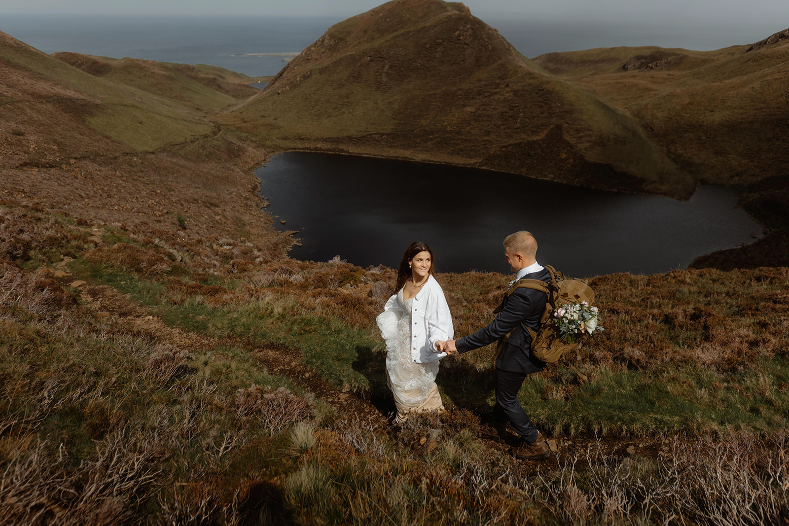 Emma and Matthew shared an intimate moment as they hike down after their Isle of Skye elopement ceremony