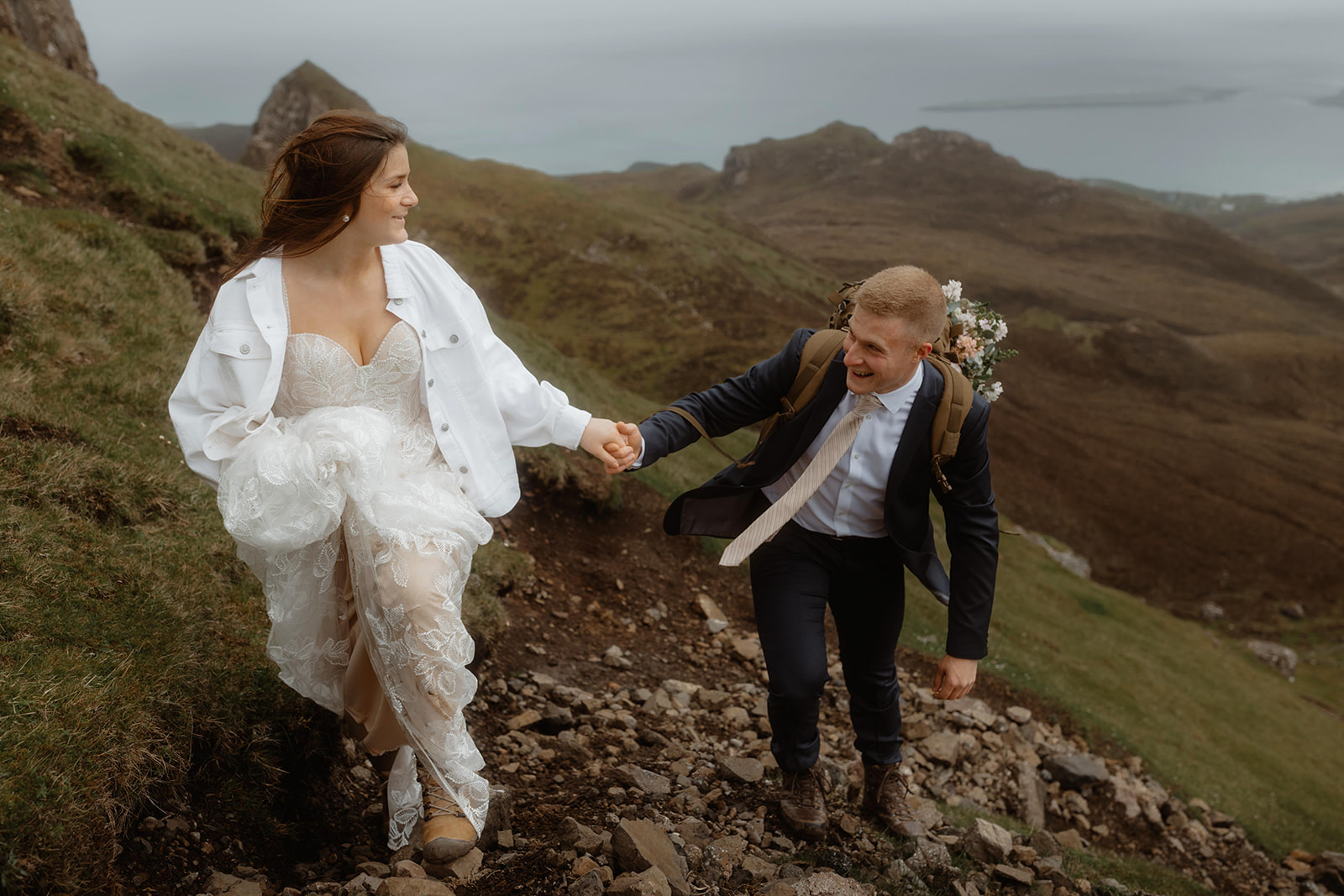Hand in hand, Emma and Matthew enjoy a romantic walk at the stunning Quiraing, Isle of Skye, on their special elopement 