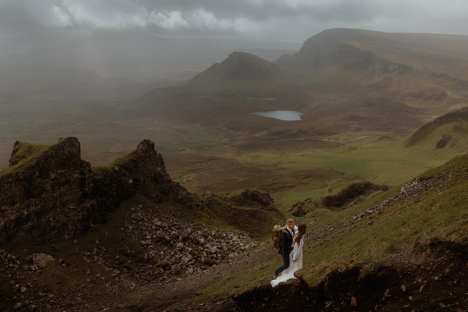Emma and Matthew embrace a romantic stroll at the Quiraing, Isle of Skye, during their enchanting elopement day.