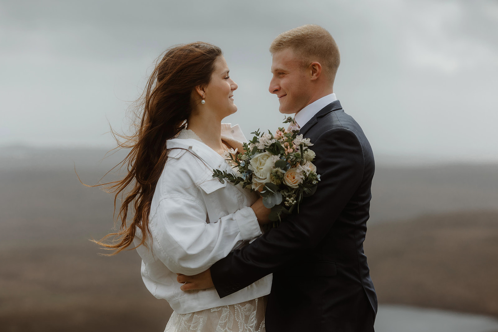 Emma and Matthew embrace on top of Quiraing, Isle of Skye for their elopement
