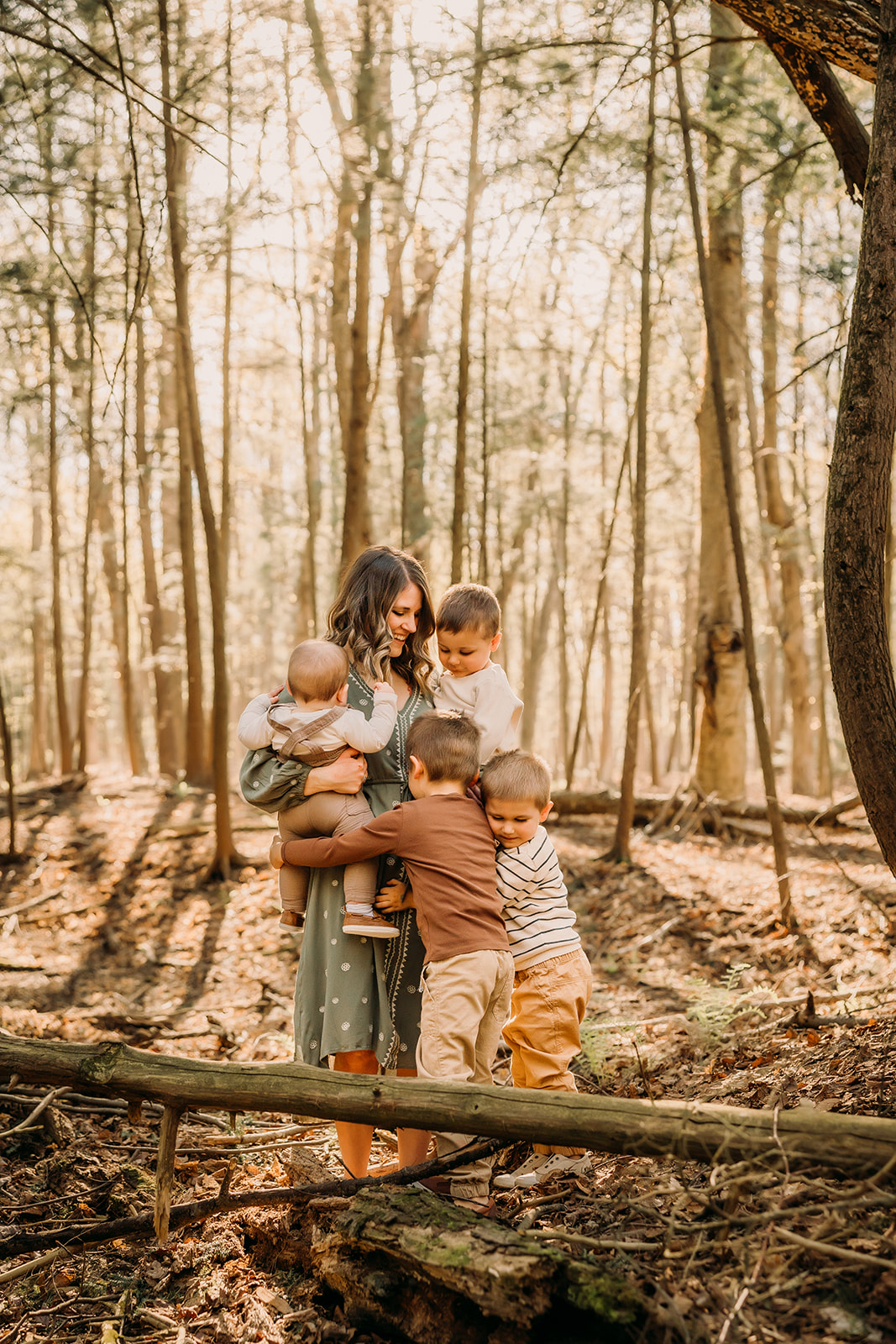 Beautiful mother and children framed by the enchanting forest scenery