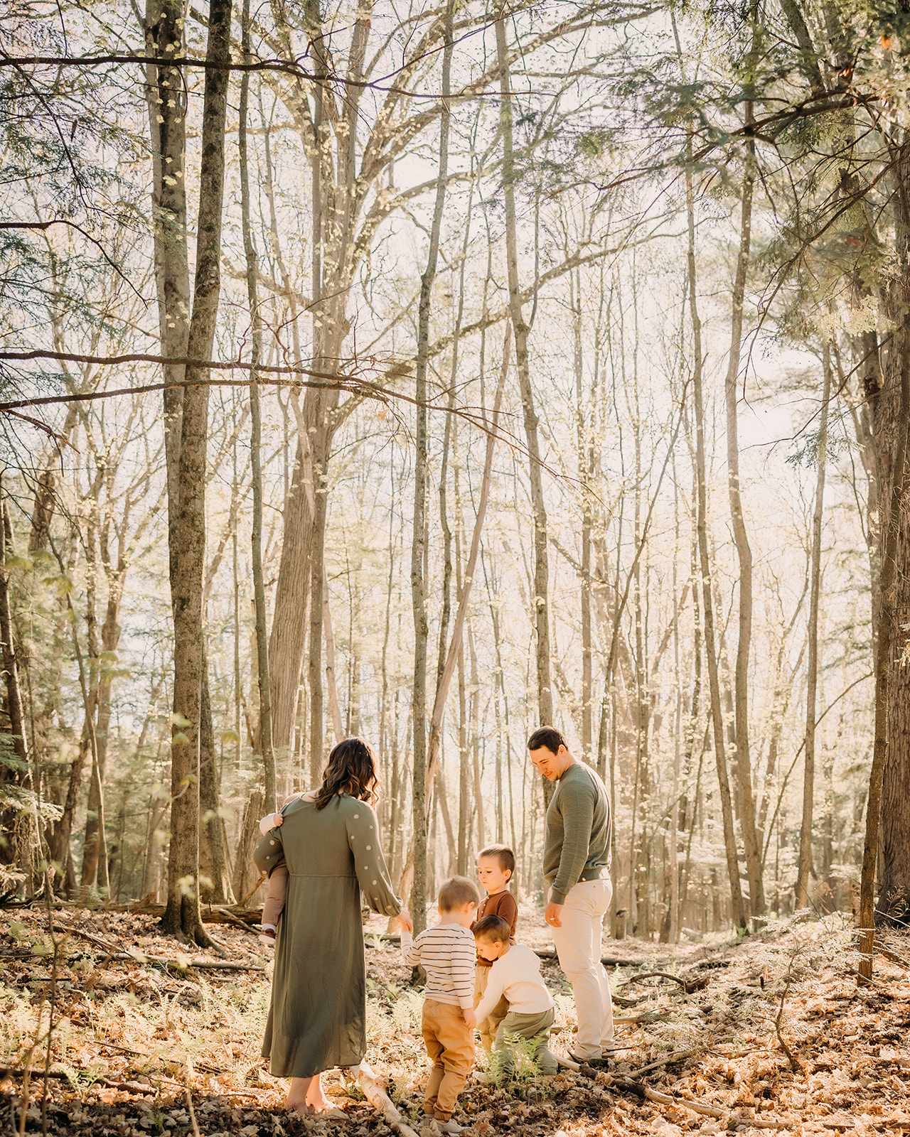 Candid moments of love and laughter in a forest photoshoot with parents and children