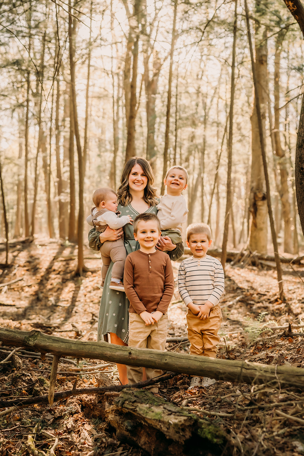 Joyful mother and children creating lasting memories in a forest photoshoot