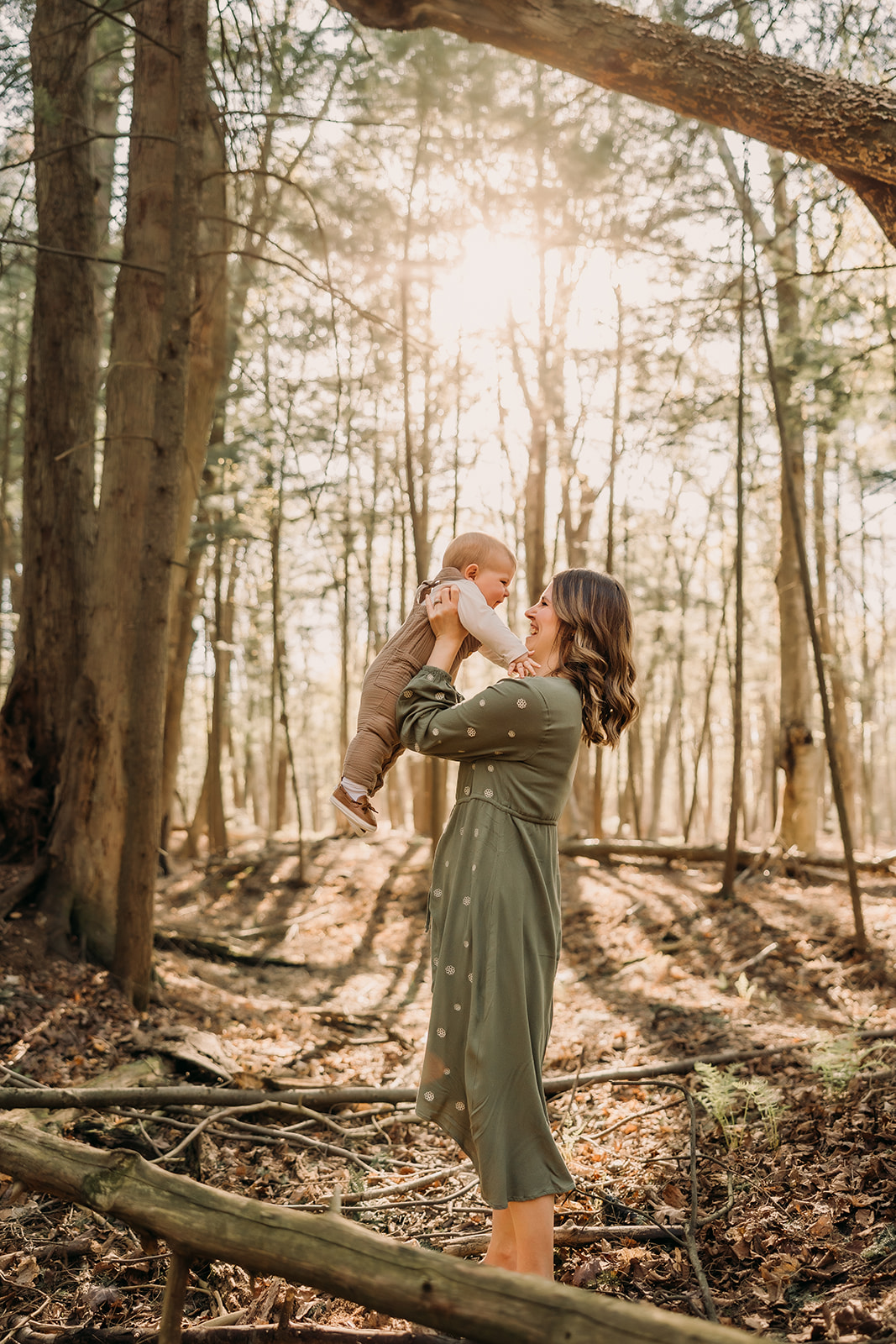 Mother and child bonding amidst the beauty of the forest in a photoshoot