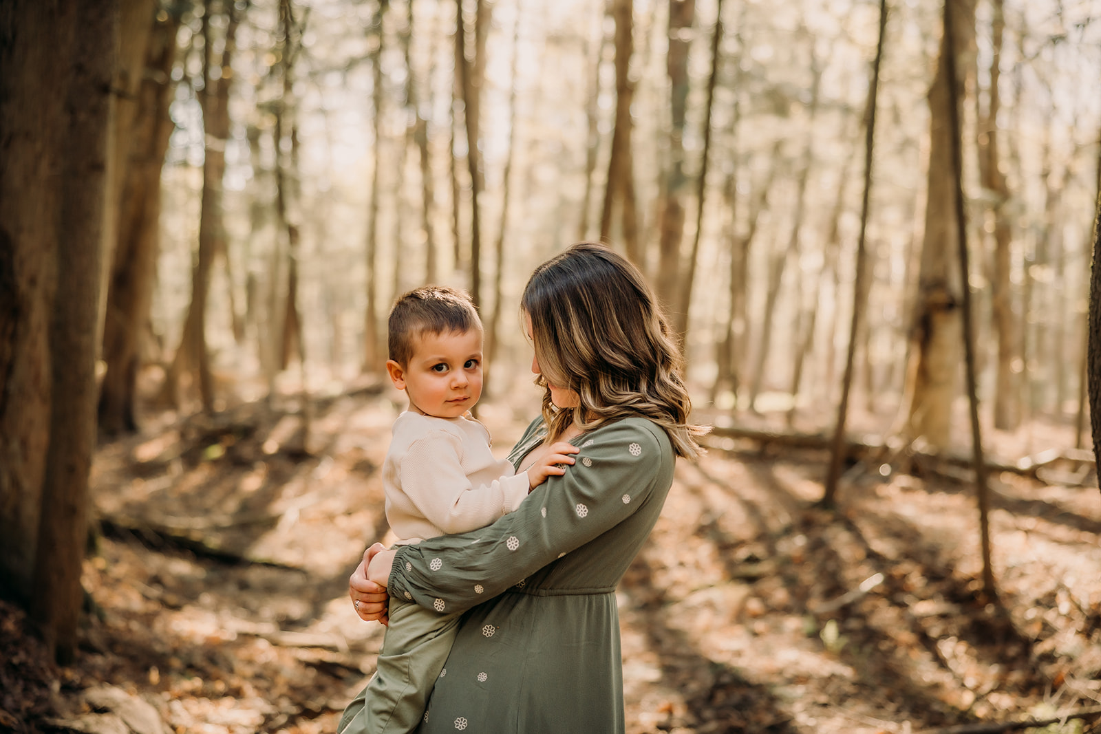 Radiant mother and child in a picturesque forest photoshoot