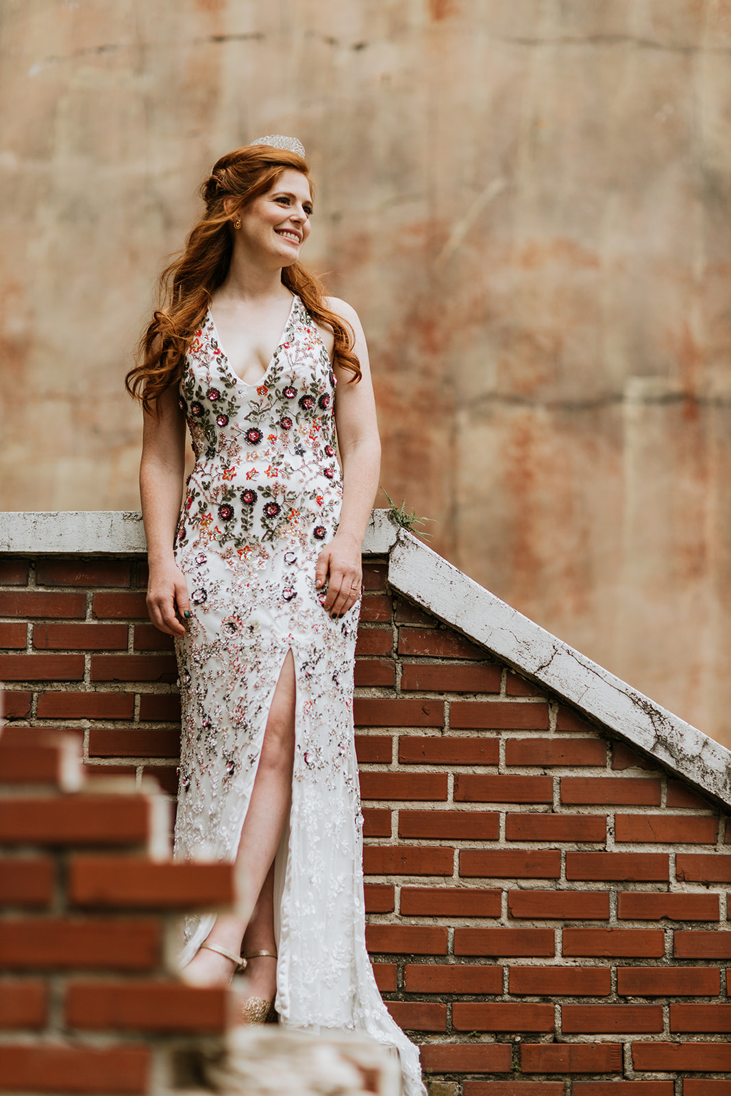 Bride glowing on her wedding day in floral wedding gown