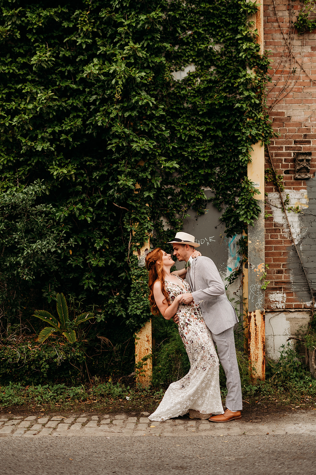 Bride and Groom dancing in floral print and a seersucker suit, a spring wedding in New Orleans