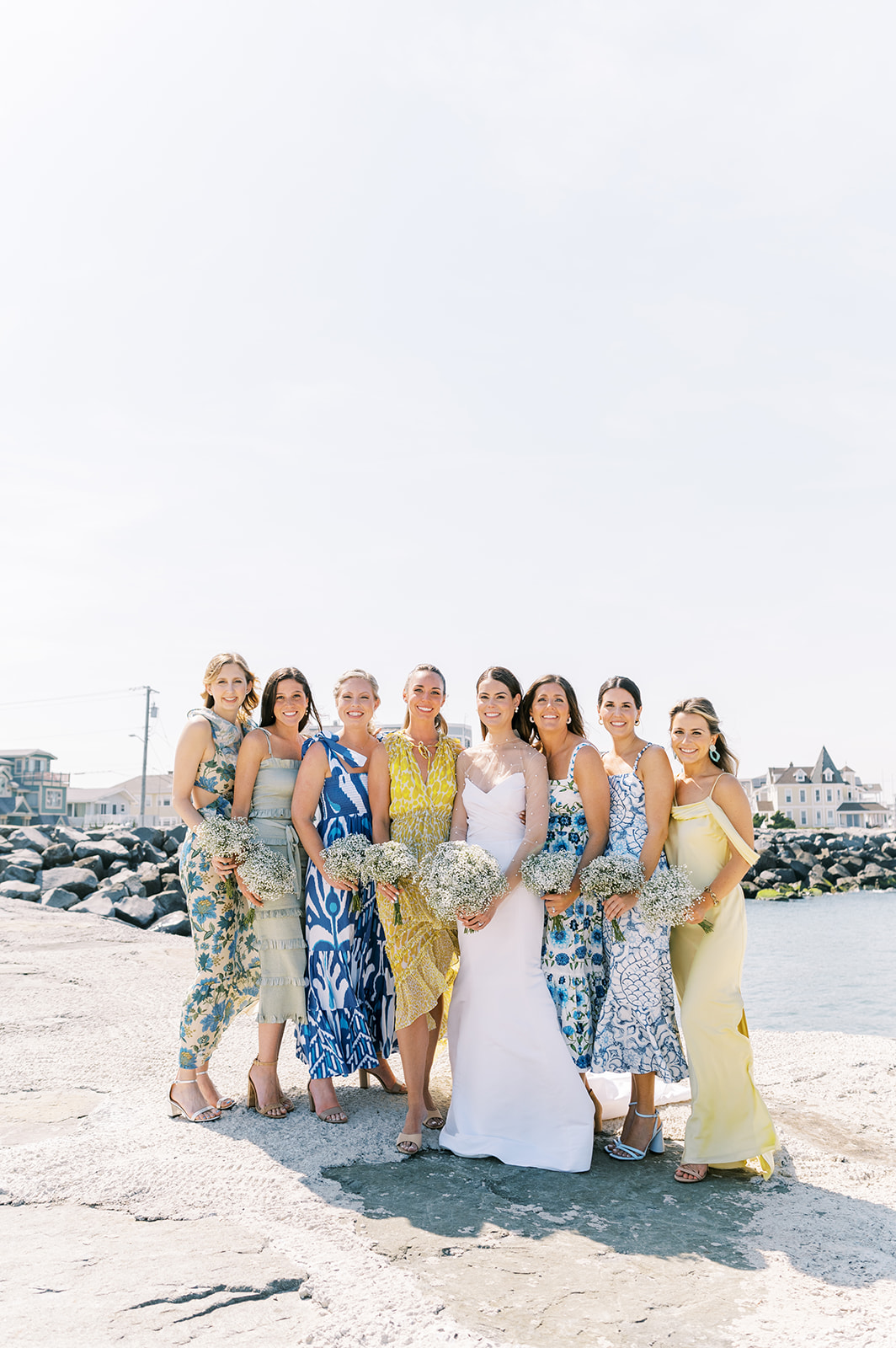 chic bridal party in preppy mismatched florals for Bright Summer Stone Harbor Golf Club Wedding in Yellow and Blue