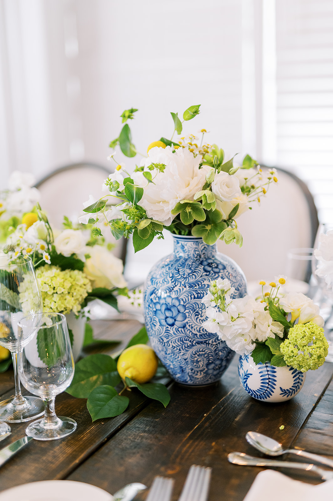 white and yellow blooms in blue vases for this Bright Summer Stone Harbor Golf Club Wedding in Yellow and Blue