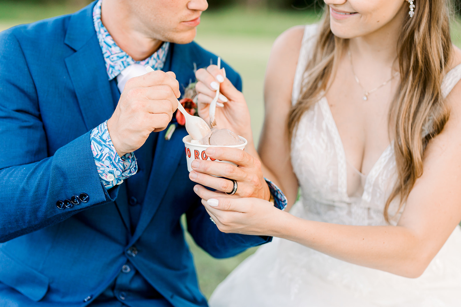 Couple sharing ice cream together on wedding day