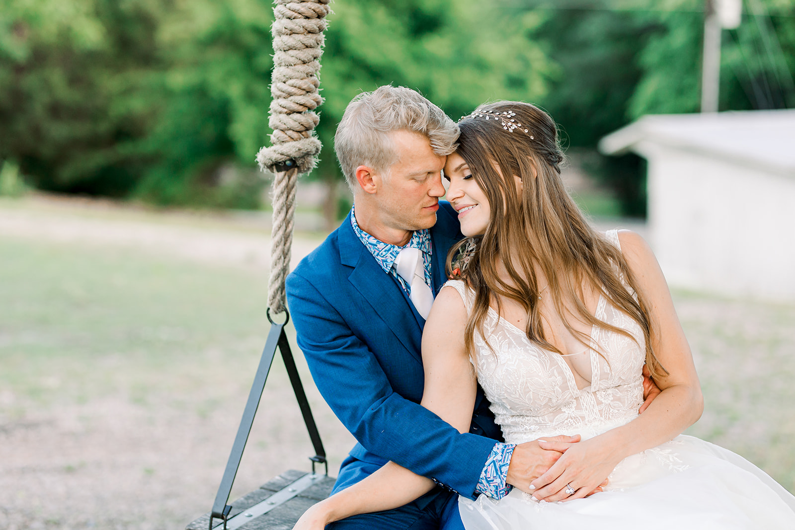 Wedding couple sitting on swing for couples portraits