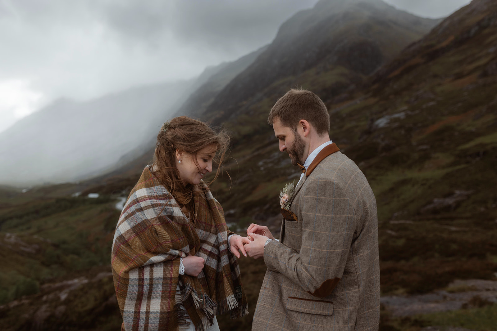 Holly and James share a romantic moment during their elopement ceremony at the majestic Glencoe, Isle of Skye