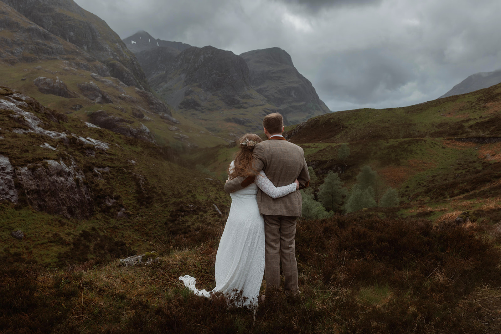 Holly and James walk hand in hand after their elopement ceremony in the majestic Glencoe on the Isle of Skye