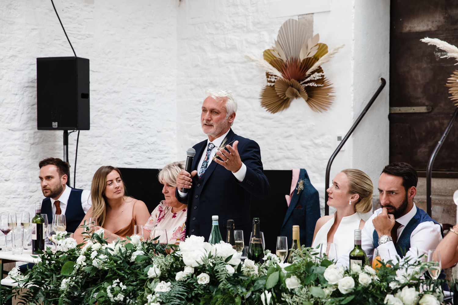 A father of the bride gives a speech to the wedding party
