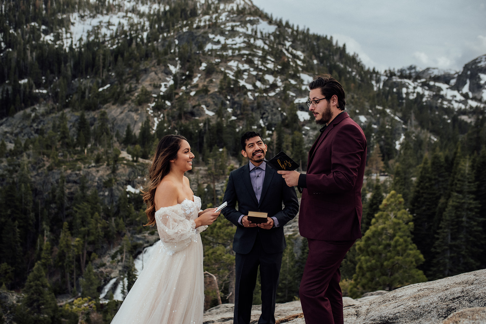 bride and groom saying vows in front of snowy mountains near Lake Tahoe